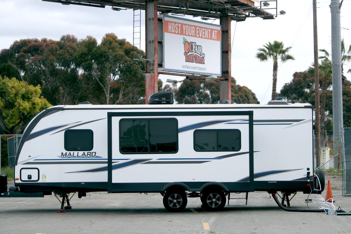 A trailer arrives Friday at the Orange County fairgrounds parking lot, where Costa Mesa will house members of its homeless population who may be vulnerable to the coronavirus.