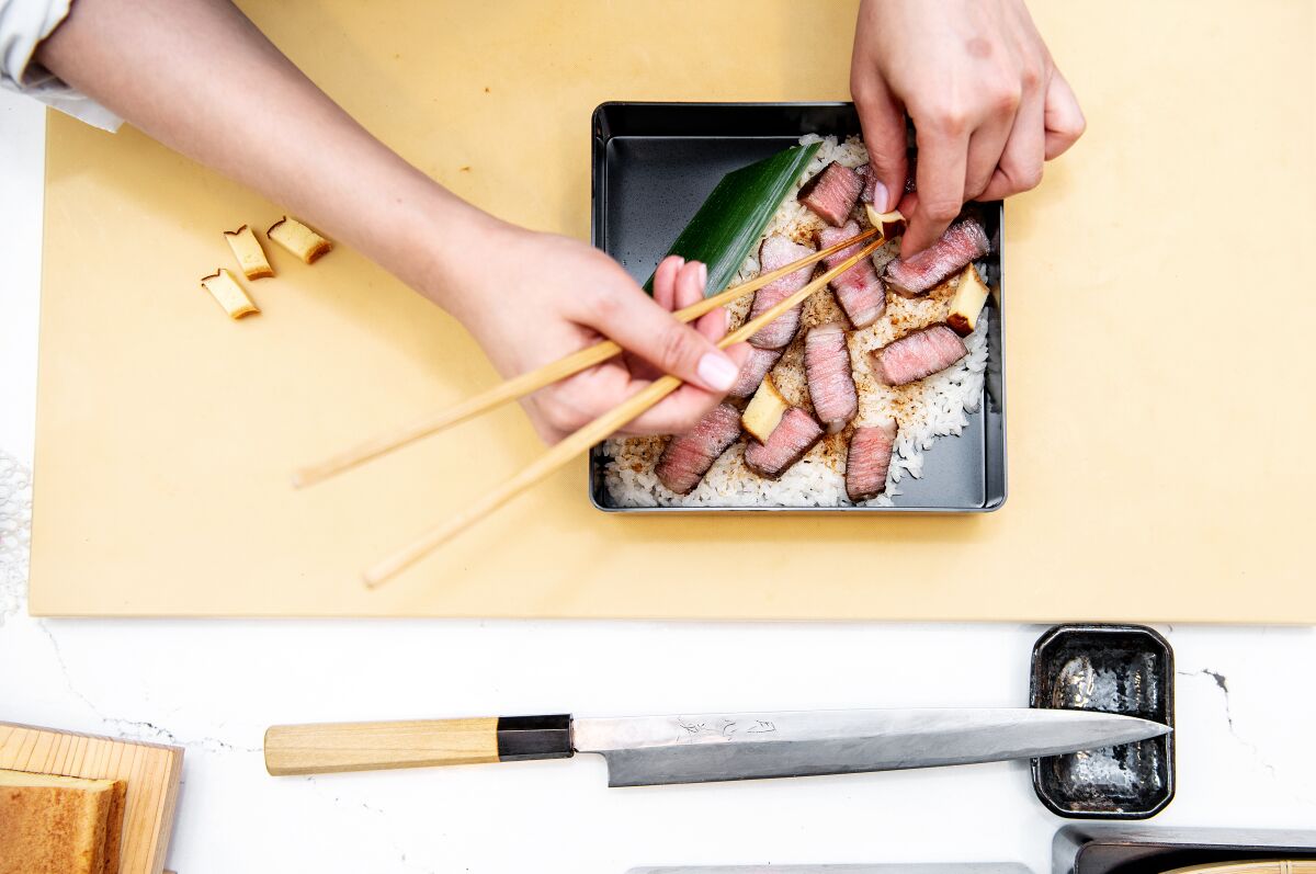 Nan Yimcharoen of Kinkan prepares ribeye chirashi .