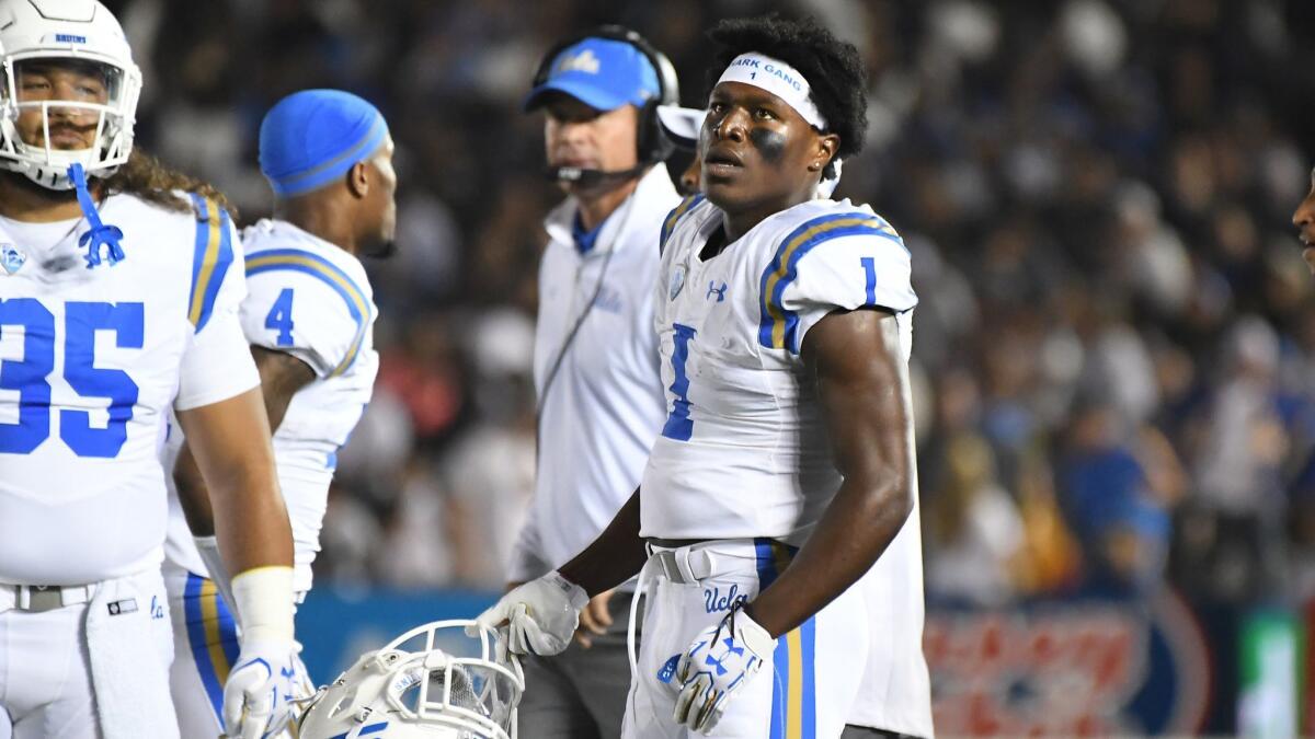 UCLA defensive back Darnay Holmes watches a replay as he is ejected from the game for targeting against Colorado in the first quarter at the Rose Bowl last season.