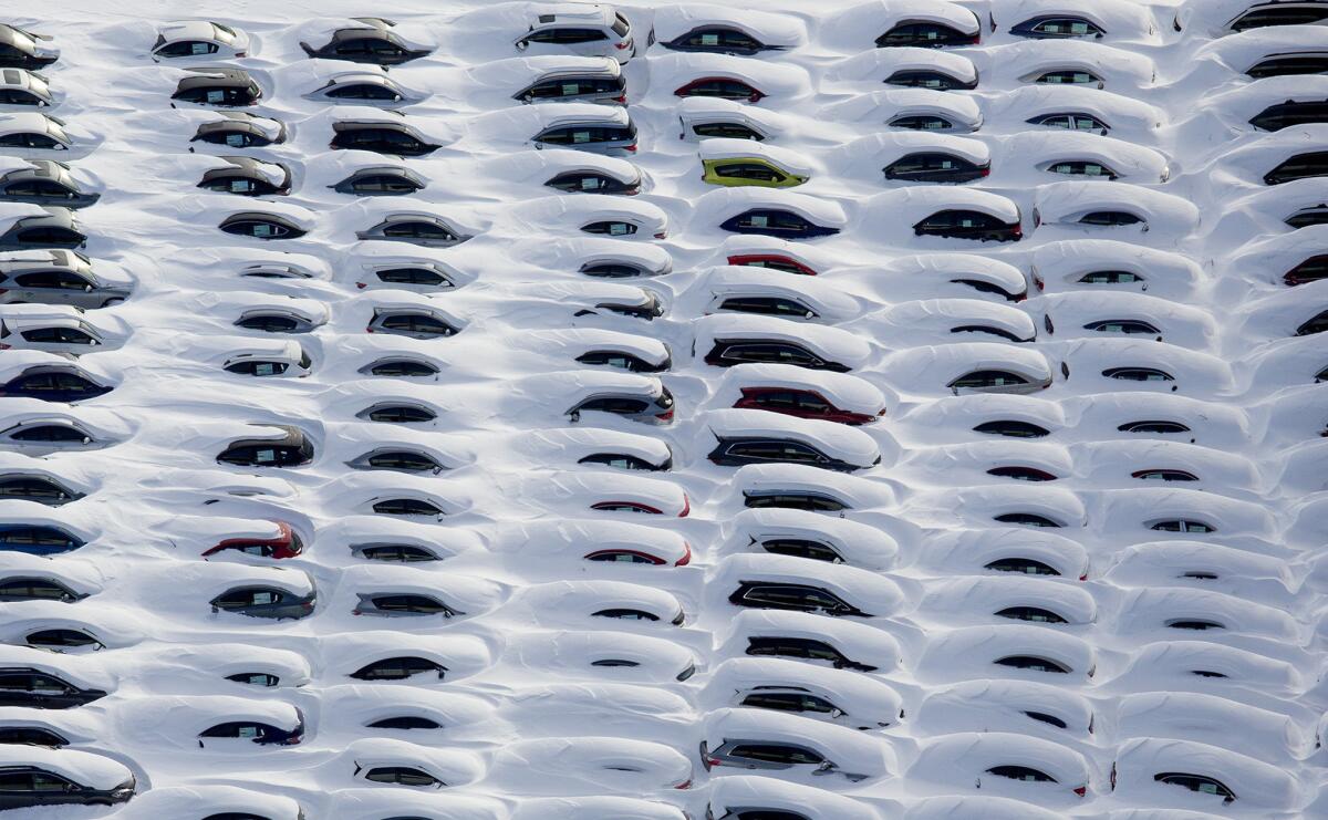 Cars are buried by snow near Hamden, Conn., after of a storm that slammed much of New England with heavy snow.