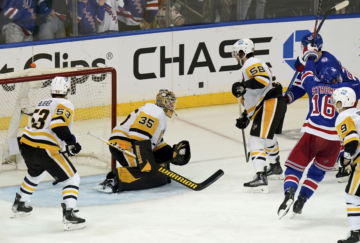A shot by New York Rangers left winger Artemi Panarin gets by Pittsburgh Penguins goaltender Tristan Jarry to win in overtime of Game 7 in an NHL hockey playoff series, Sunday, May 15, 2022, at Madison Square Garden in New York. (Matt Freed/Pittsburgh Post-Gazette via AP)
