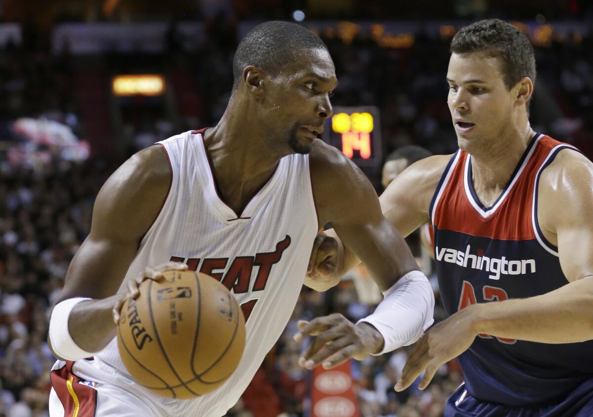 Miami Heat forward Chris Bosh, left, drives past Washington Wizards forward Kris Humphries on Wednesday night.