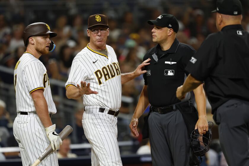 SAN DIEGO, CA - AUGUST 23: San Diego Padres' Brandon Drury and manager Bob Melvin argue a strike call with umpire Stu Scheurwater in the fourth inning against the Cleveland Guardians at Petco Park on Tuesday, August 23, 2022 in San Diego, CA. (K.C. Alfred / The San Diego Union-Tribune)