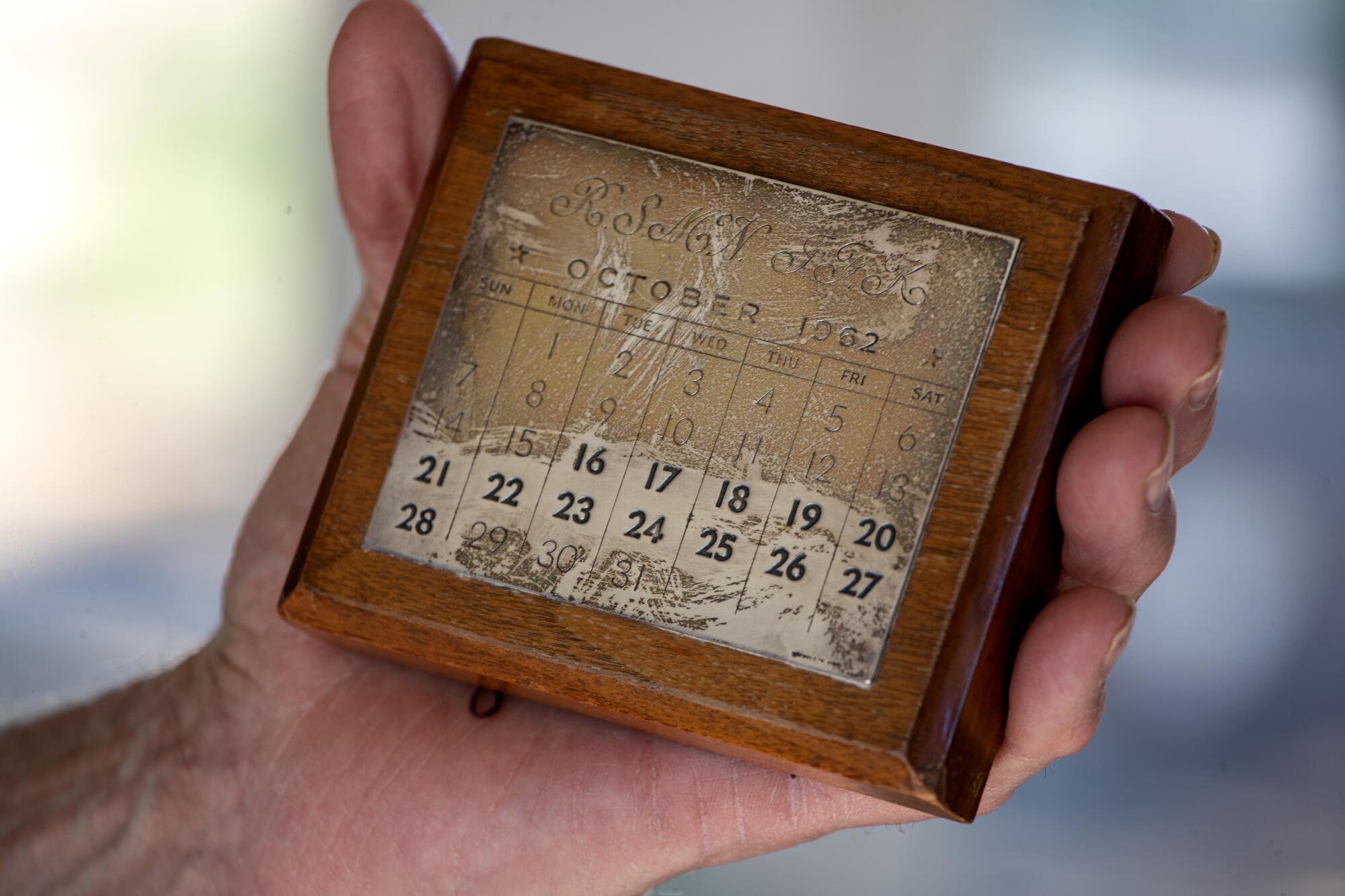 Walnut farmer and activist Craig McNamara holds a commemorative calendar from the days of the Cuban missile crisis.
