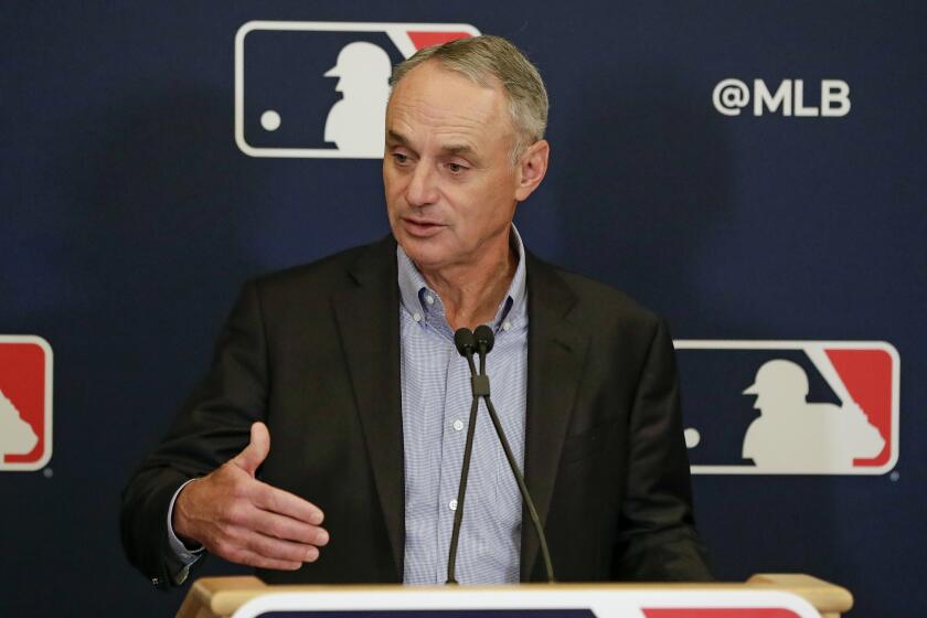 In this Feb. 6, 2020, file photo, MLB Commissioner Rob Manfred answers questions at a news conference.