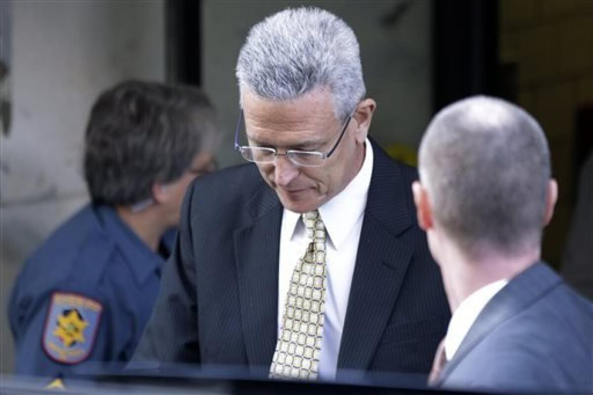 Former Penn State director of athletics Tim Curley exits the Dauphin County Courthouse, Monday, July 29, 2013, in Harrisburg, Pa. Curley faces charges in the child sex abuse scandal involving former assistant football coach Jerry Sandusky. (AP Photo/Matt Rourke)