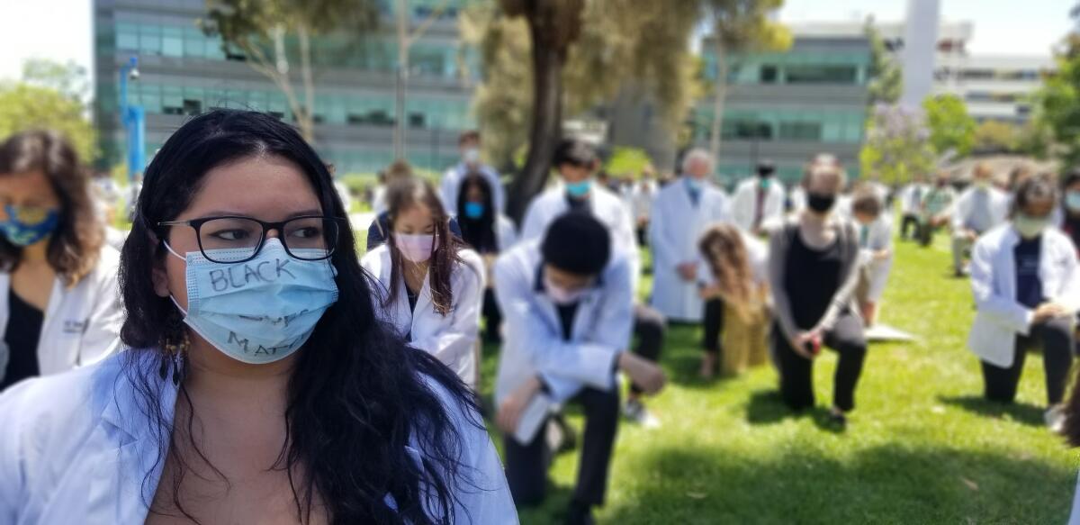 UC San Diego medical school students kneel during an anti-racism rally on the La Jolla campus in June 2020.