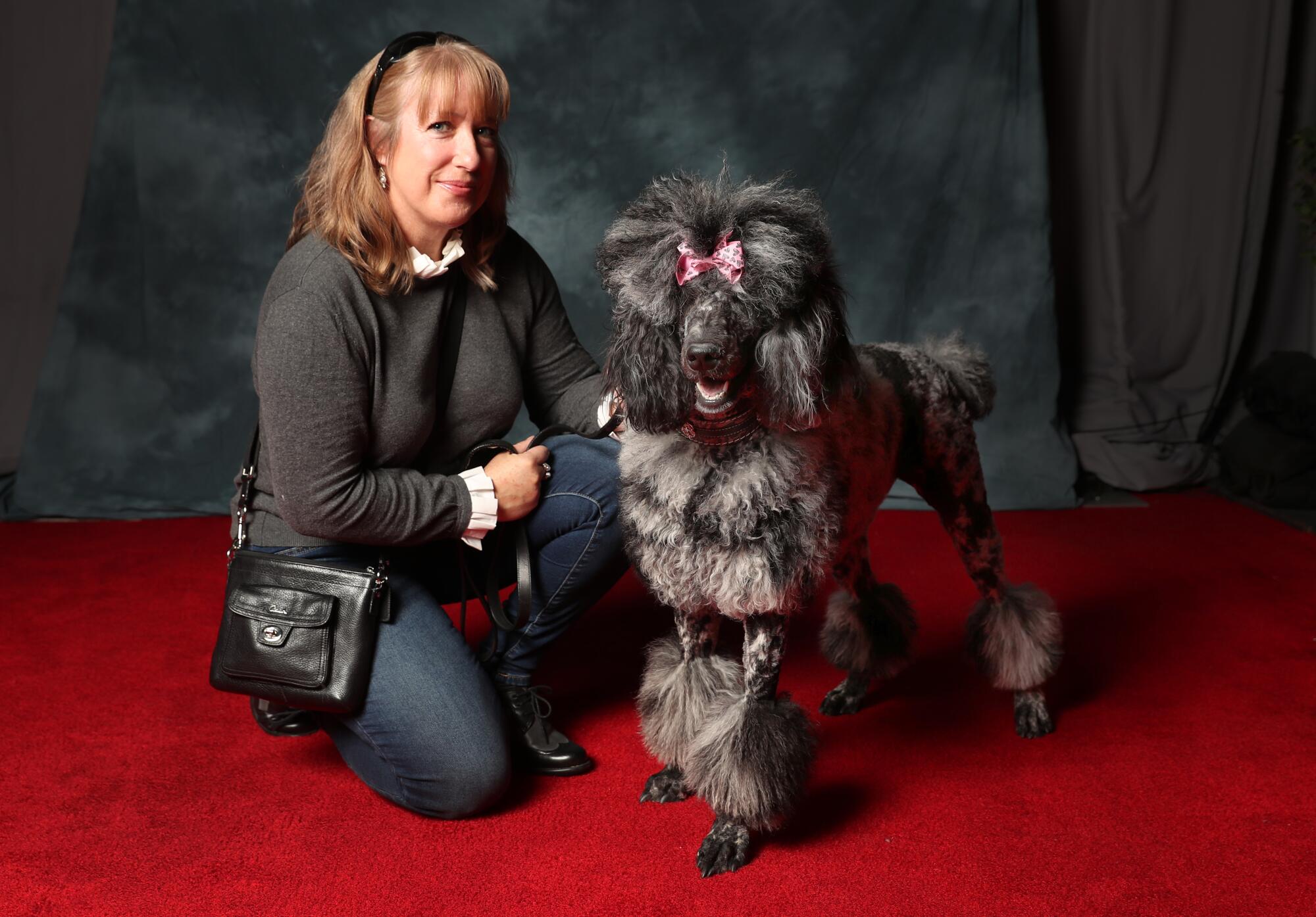 Sandra Smith of Norco poses with Cosette, a 14-month-old silver and black poodle standard.