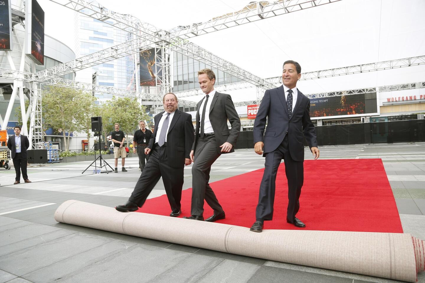 From left, Ken Ehrlich, Television Academy chairman and co-producer of this year's telecast; Neil Patrick Harris, this year's host and co-producer; and Academy of Television Arts & Sciences CEO Bruce Rosenblum roll out the red carpet for the 65th Primetime Emmy Awards at the Nokia Theatre Sunday, airing live on CBS at 5 p.m. PDT.