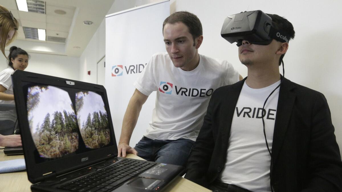 Vrideo co-founders Alex Rosenfeld, left, and Kuangwei Hwang with the Oculus VR viewer at a meet-up in Santa Monica in 2015. Vrideo ended up closing because it ran out of funding.