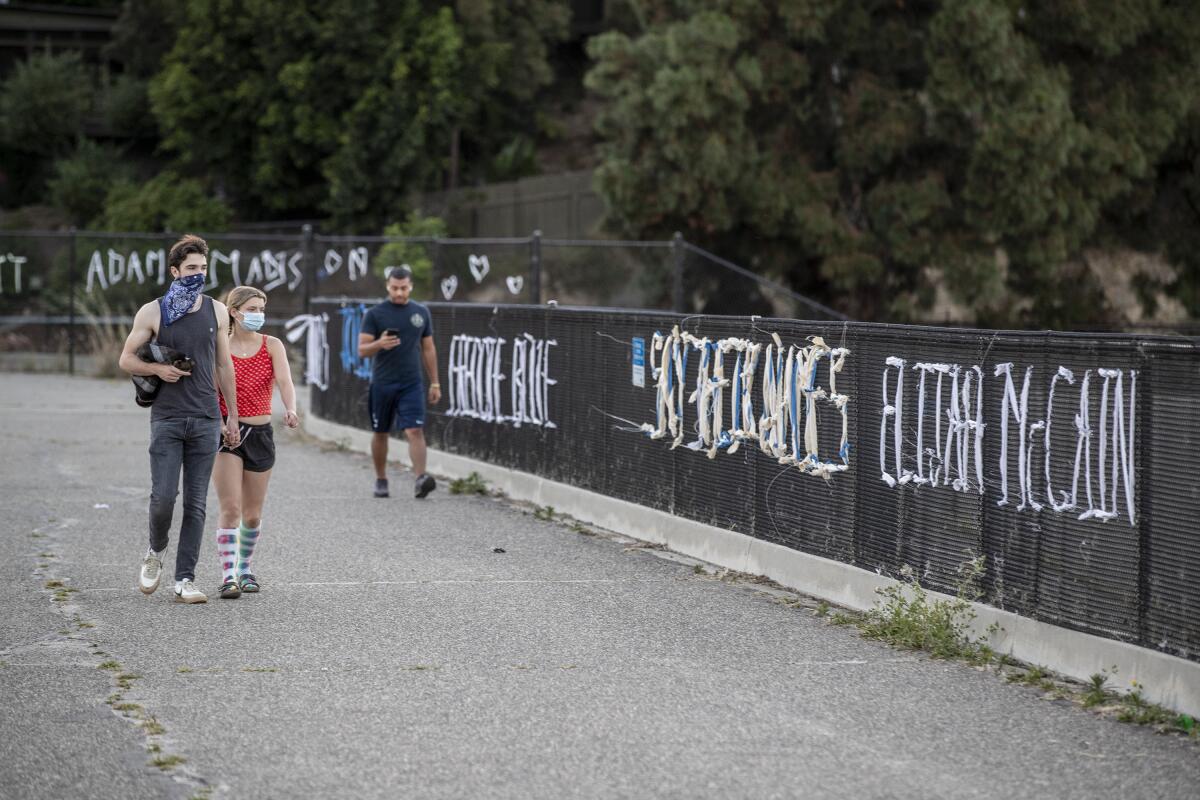 Colorful fabric forms the names of unarmed black people killed by police in a memorial at Silver Lake Reservoir