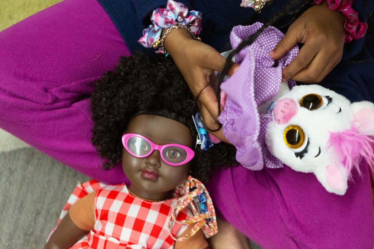 Crete Academy students groom their dolls during a group therapy session at Crete Academy. 