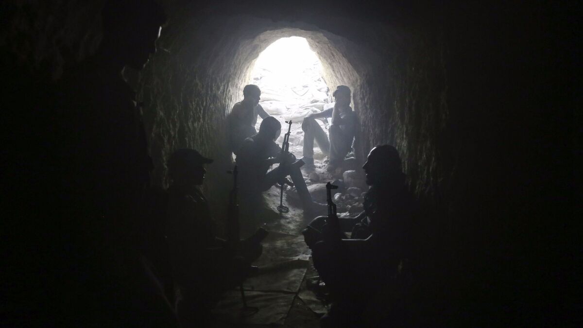 Syrian rebel fighters hold a position inside a tunnel in Ain Tarma, in the eastern Ghouta area, a rebel stronghold east of the capital, Damascus, on Aug. 16.