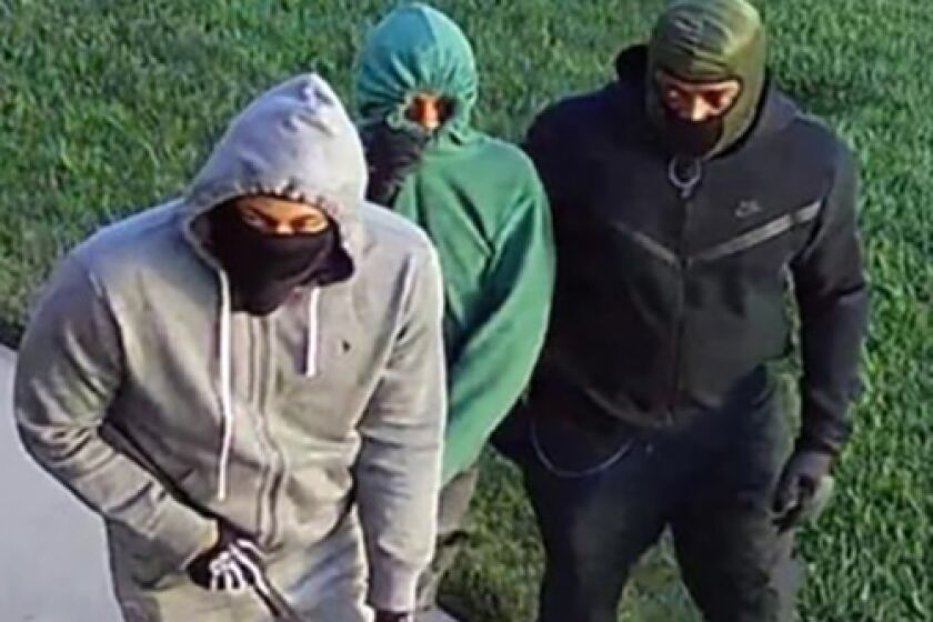Authorities are searching for three men accused of forcing their way into a home and stealing cash and property.