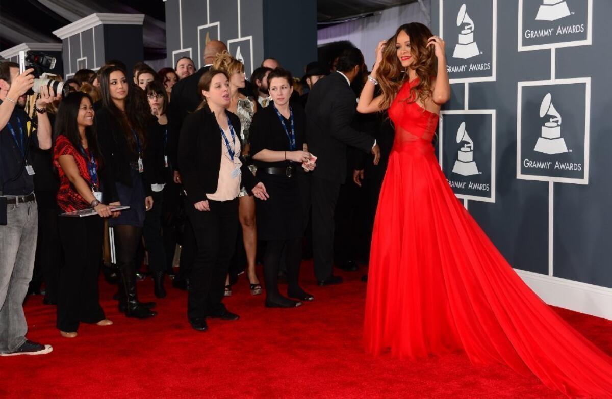 Rihanna draws attention in an elegant gown at the 55th Grammy Awards on Sunday.