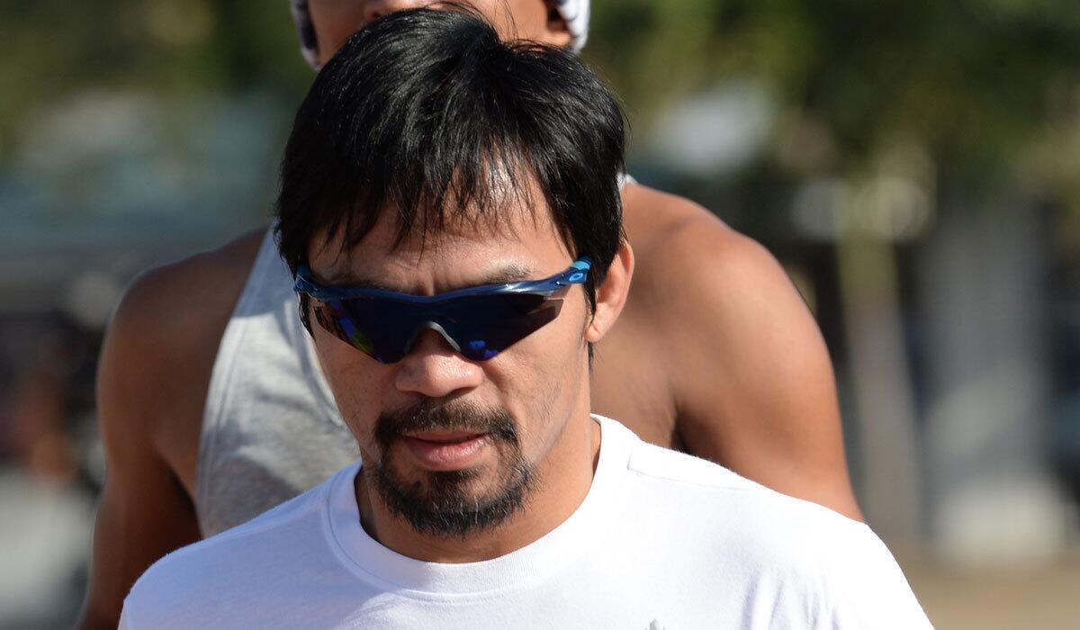 Philippine boxing great Manny Pacquiao jogs as part of his training ahead of his bout with Timothy Bradley in April.