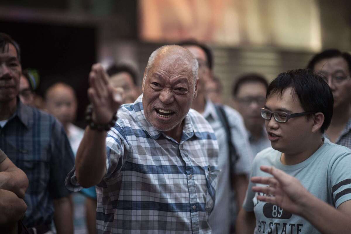 A man argues with a pro-democracy protester in the Mong Kok district of Hong Kong on Oct. 24.
