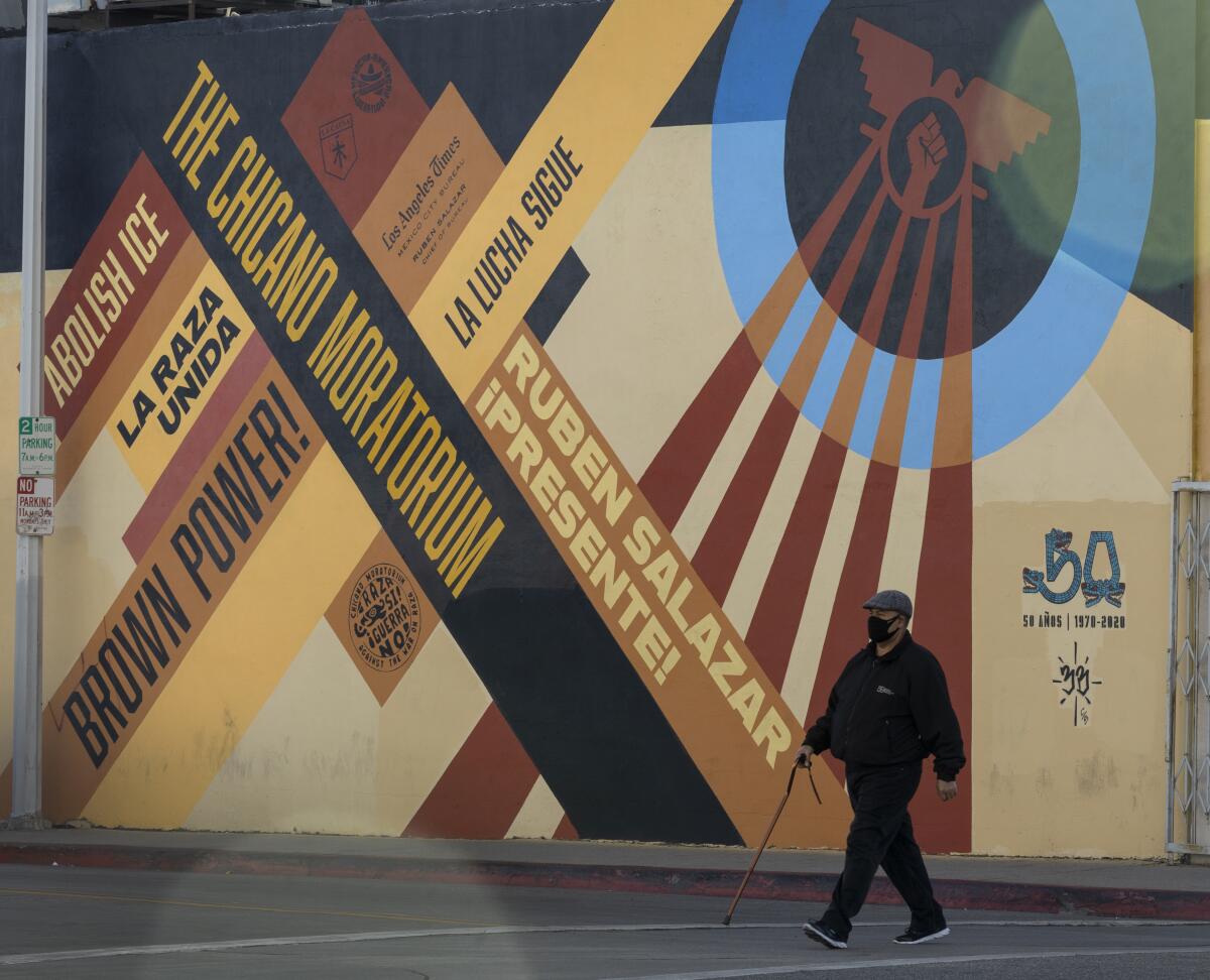 A pedestrian walks across Whittier Boulevard 