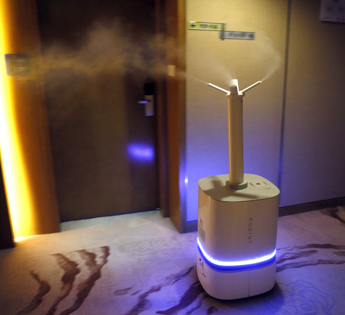 Robot sprays disinfectant in a hallway of the Crown Plaza hotel in Beijing.