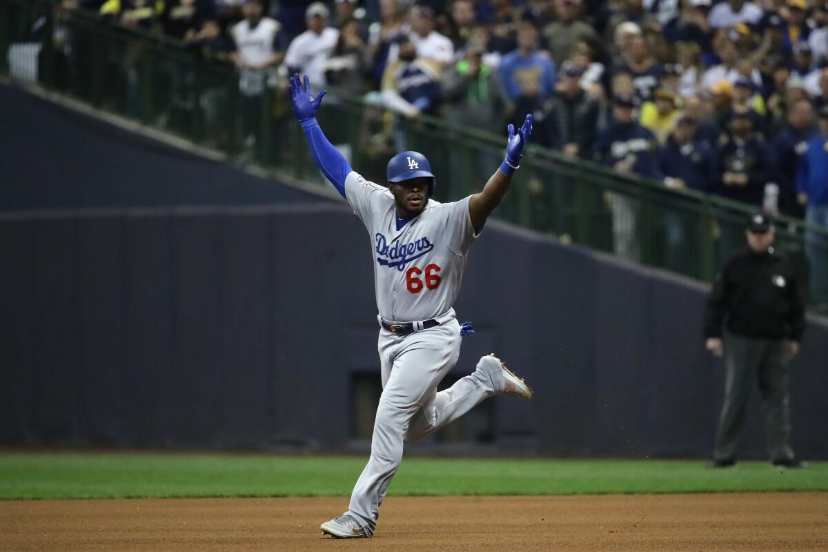 Dodgers' Yasiel Puig celebrates after hitting a three-run home run against the Milwaukee Brewers.