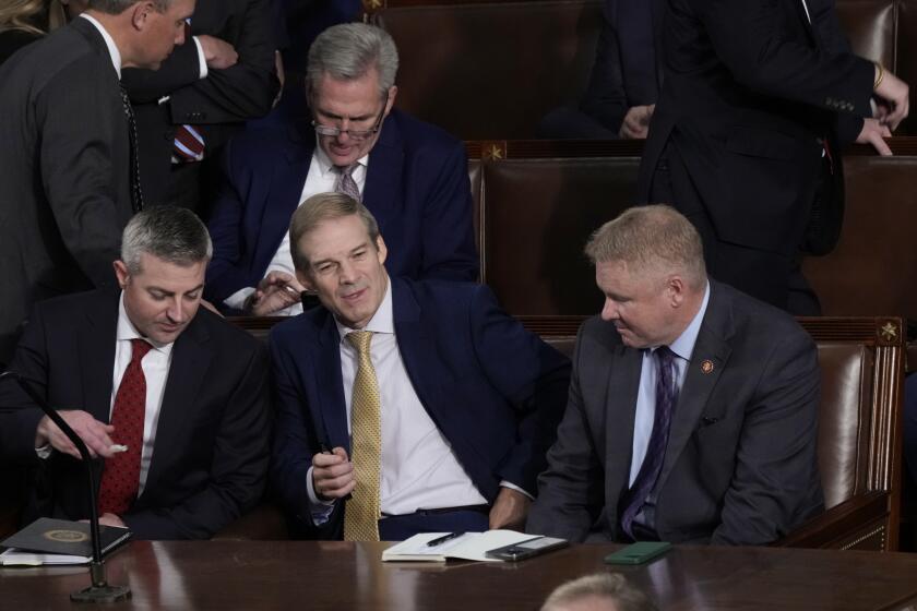 Rep. Jim Jordan, R-Ohio, chairman of the House Judiciary Committee, seated center, talks to Rep. Warren Davidson, R-Ohio, right, and a House staff member, left, as Republicans try to elect Jordan, a top Donald Trump ally, to be the new House speaker, at the Capitol in Washington, Tuesday, Oct. 17, 2023, as former Speaker of the House Rep. Kevin McCarthy, R-Calif., sits behind them. (AP Photo/J. Scott Applewhite)