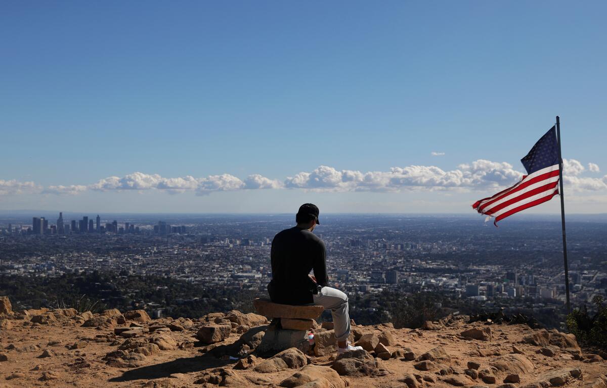 Los Angeles resident Brian Park takes a break after hiking to the Wisdom Tree in Griffith Park.