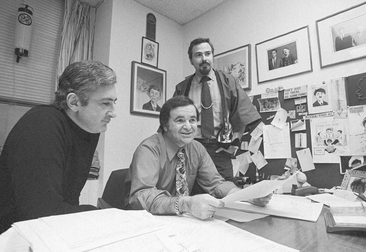 A May 1972 photograph of Mad magazine Editor Al Feldstein, center, in his office. As editor, he boosted circulation from around 375,000 to more than 2 million.