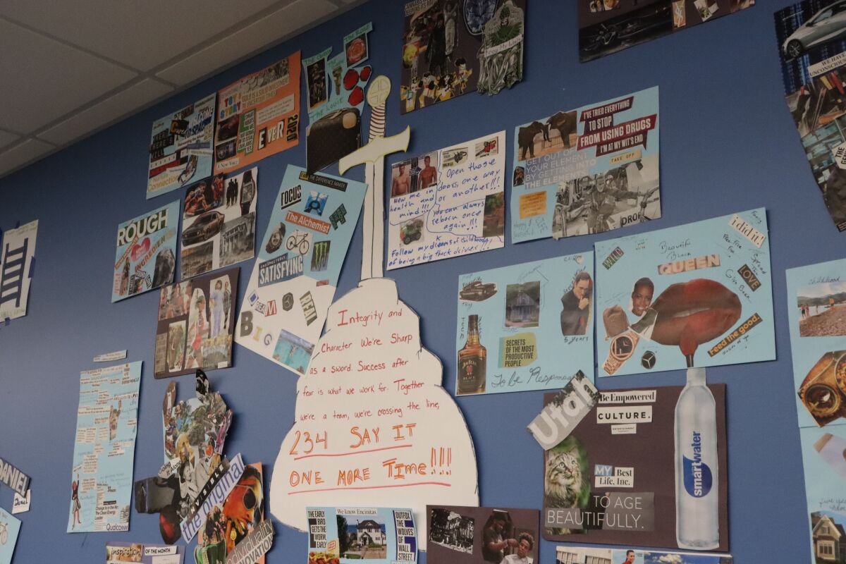 A classroom bulletin board displays the motto and projects of previous Second Chance program participants .