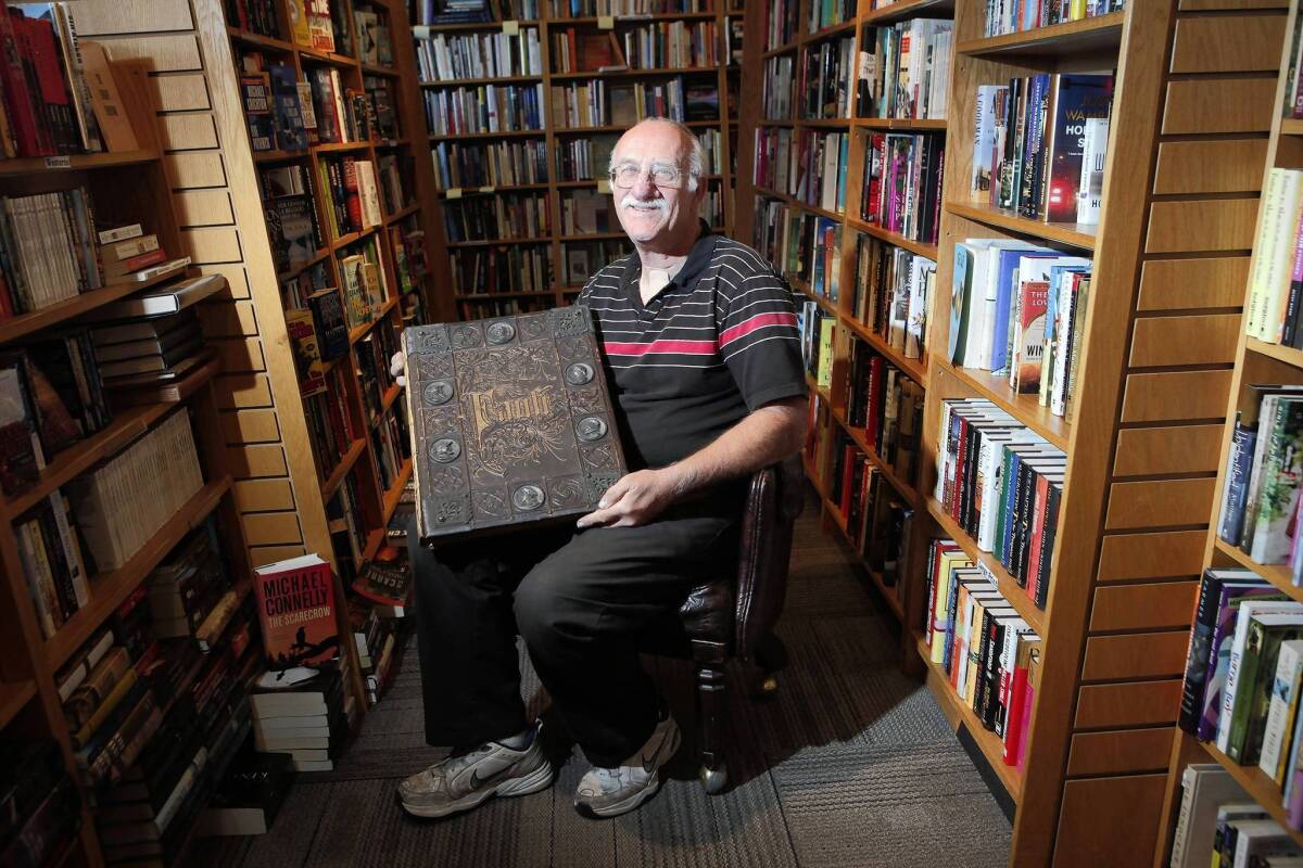 Clarey Rudd, owner of the new Bank of Books, Malibu, holds an 1877 copy of "Faust: A Tragedy," on sale for $6,850. For a brick-and-mortar bookstore to survive today, the basics are not enough. So Rudd has learned to customize, and to cater to his clients.