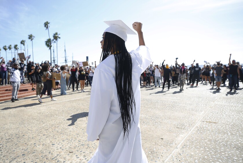 Alexys Davis, who was taking graduation photos in San Diego, was cheered on by George Floyd protesters on Sunday. 