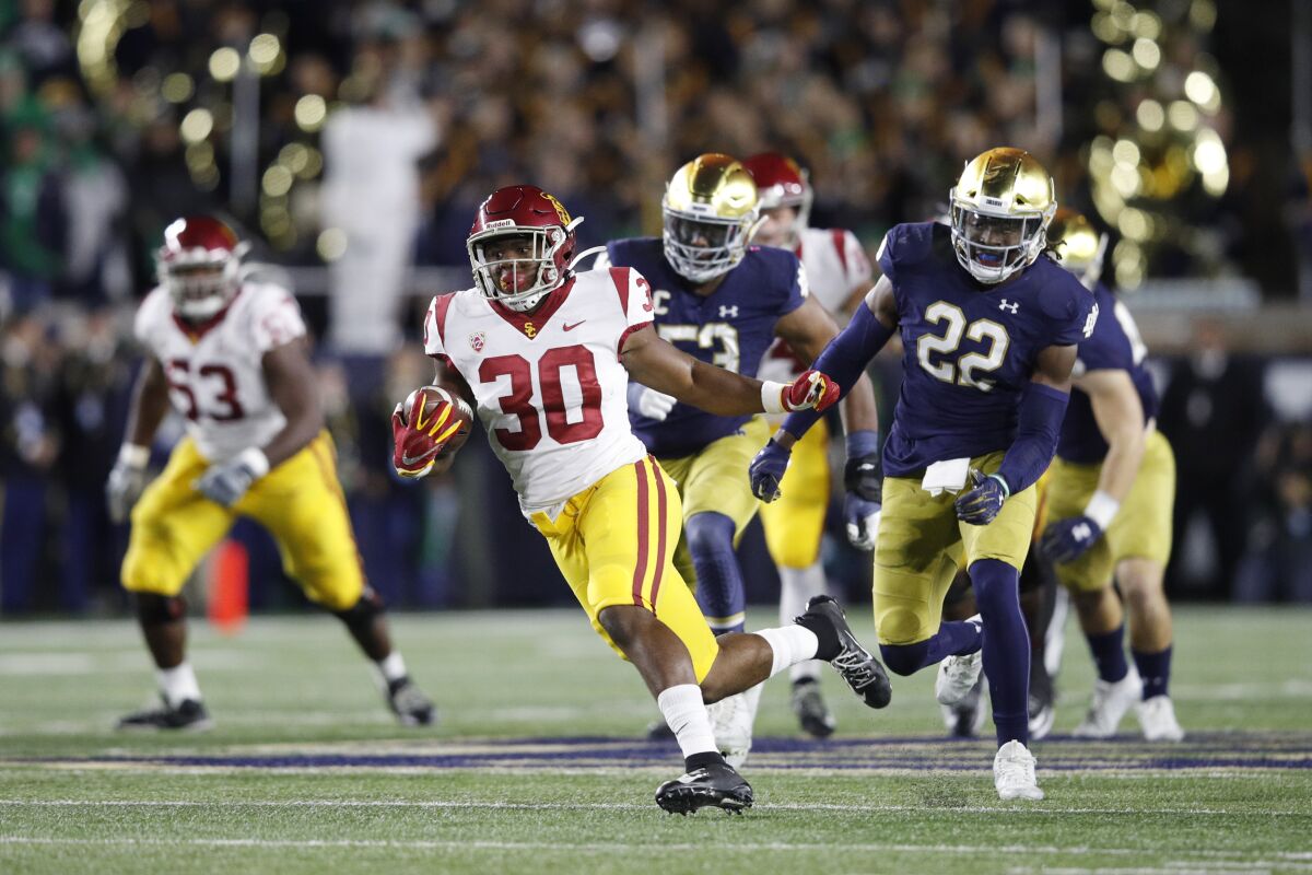 USC's Markese Stepp (30) rushes for a 19-yard gain against Notre Dame in the first half Saturday in South Bend, Ind.