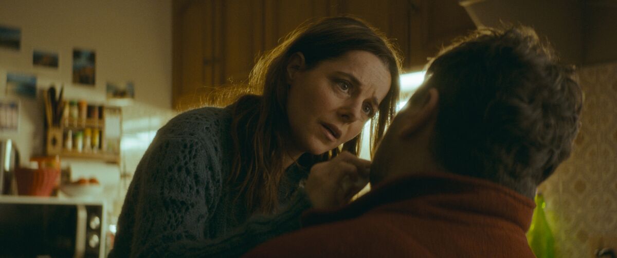 A woman touches the face of a man in the movie “Only the Animals.”
