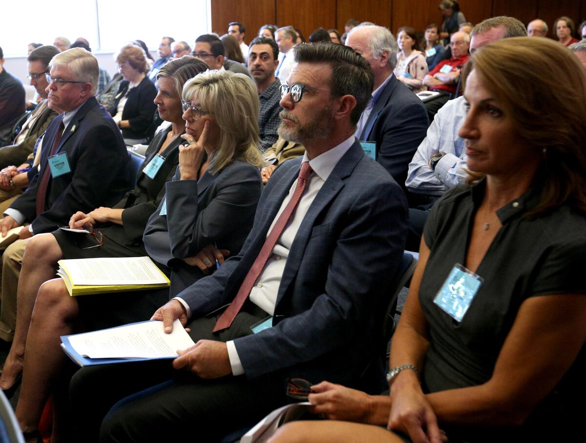 Residents and officials from the La Cañada and Glendale Unified School Districts, including La Cañada Unified Supt. Wendy Sinnette, third from right, on Wednesday convened at the Los Angeles County Office of Education where the Los Angeles County Committee on School District Organization voted to approve the transfer of the Sagebrush territory from Glendale Unified's stewardship to La Cañada Unified.