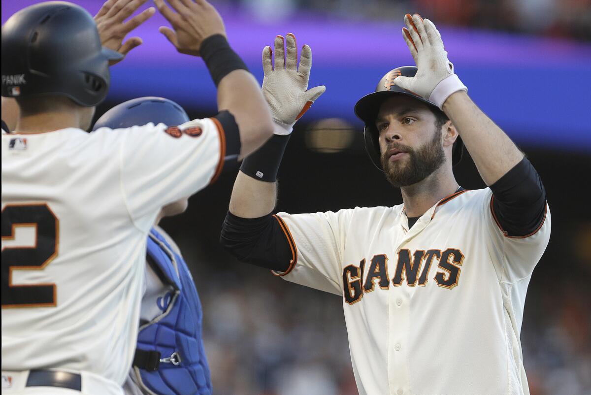 Giants first baseman Brandon Belt, right, celebrates with Joe Panik after hitting a two-run home run in the sixth inning.