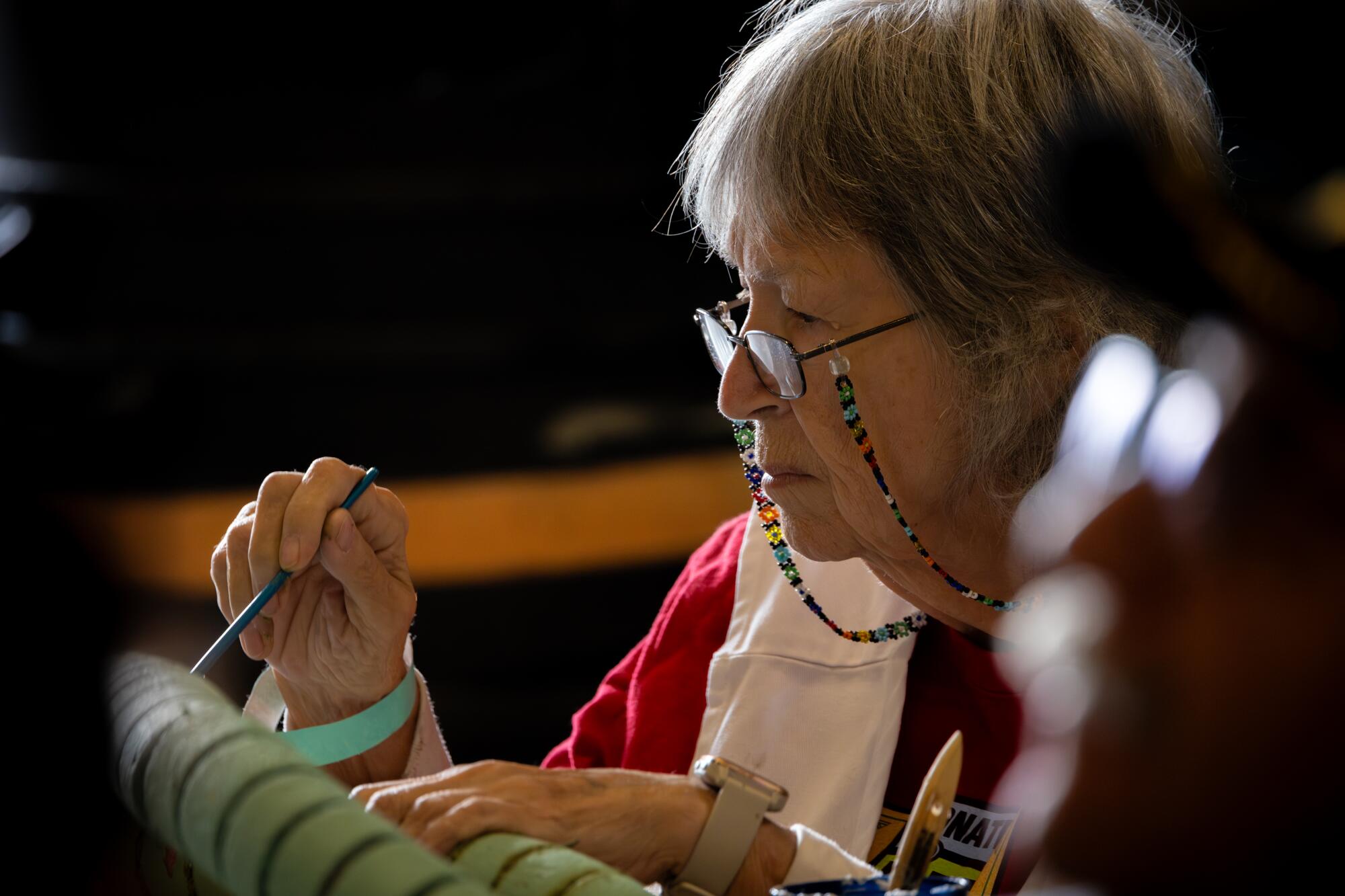 A woman does detail work on a Rose Parade float in Irwindale.