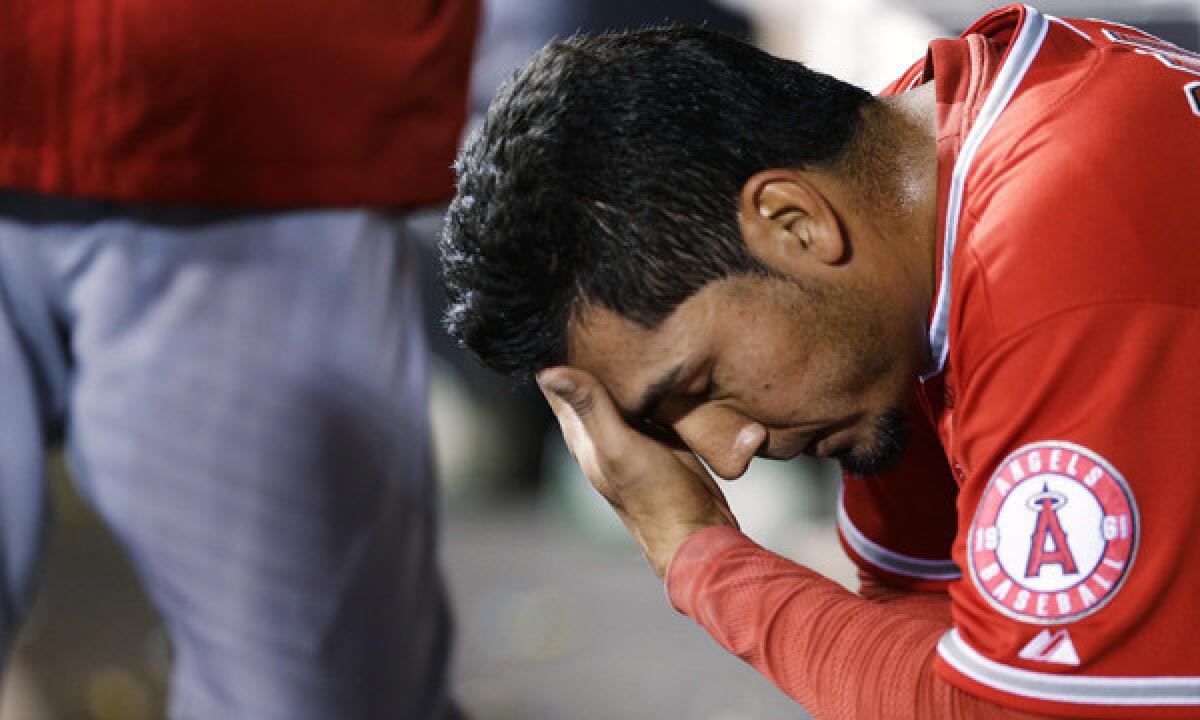 Angels reliever Fernando Salas sits in the dugout after being pulled from a game against the Seattle Mariners on April 8 after surrendering a solo home run. The Angels bullpen has struggled with its consistency this season.