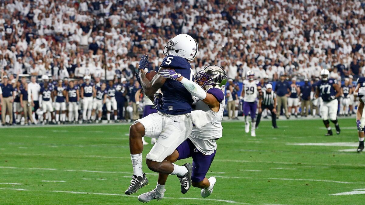 Penn State wide receiver DaeSean Hamilton (5) pulls in a touchdown catch as Washington defensive back Myles Bryant defends during the second half of the Fiesta Bowl.