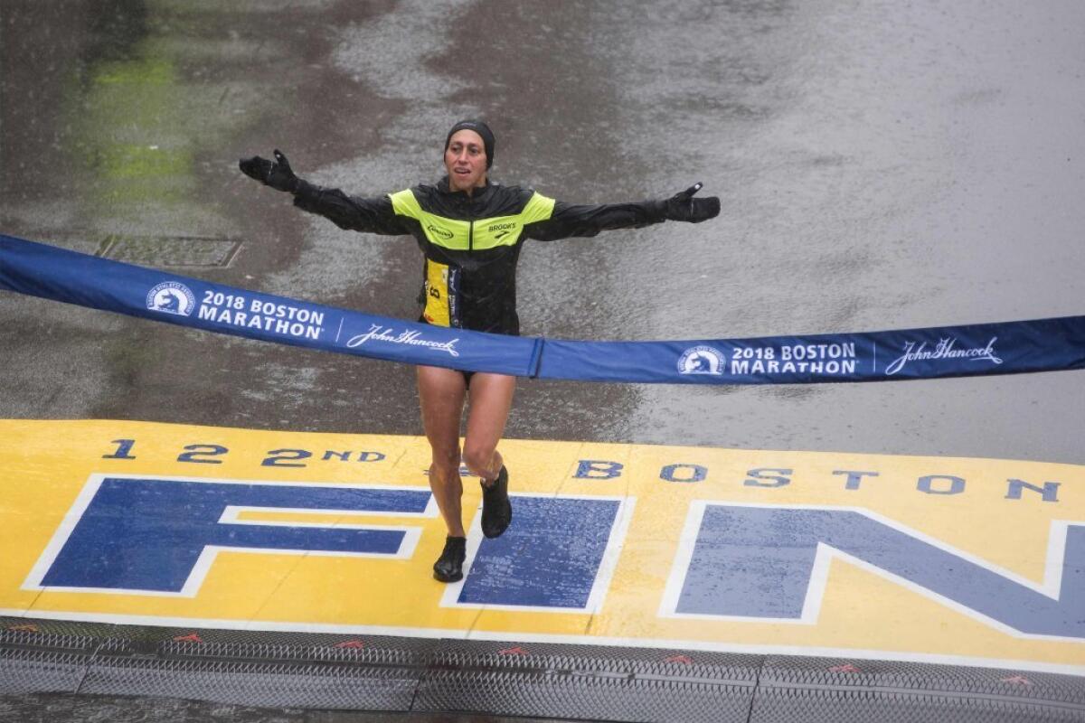 Desiree Linden of the United States crosses the finish line as the winner of the 2018 and 122nd Boston Marathon for Elite Women's race with a time of 2:39:54 on April 16, 2018 in Boston, Massachusetts.