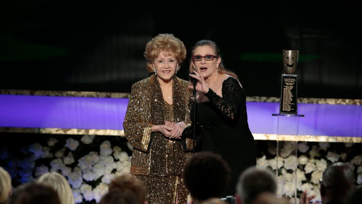 Life Achievement Award recipient Debbie Reynolds with presenter, her daughter Carrie Fisher, at the 21st Screen Actors Guild Awards.