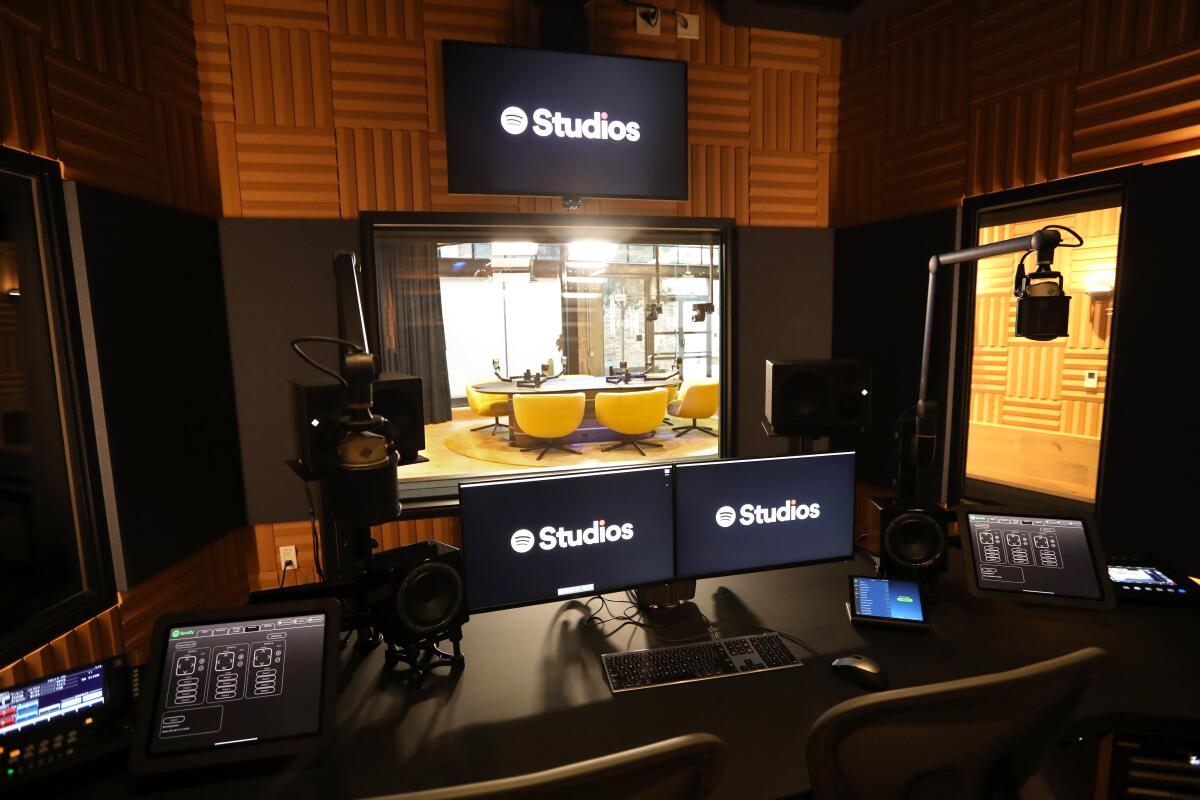 An engineering room with monitors, control panels and microphone.