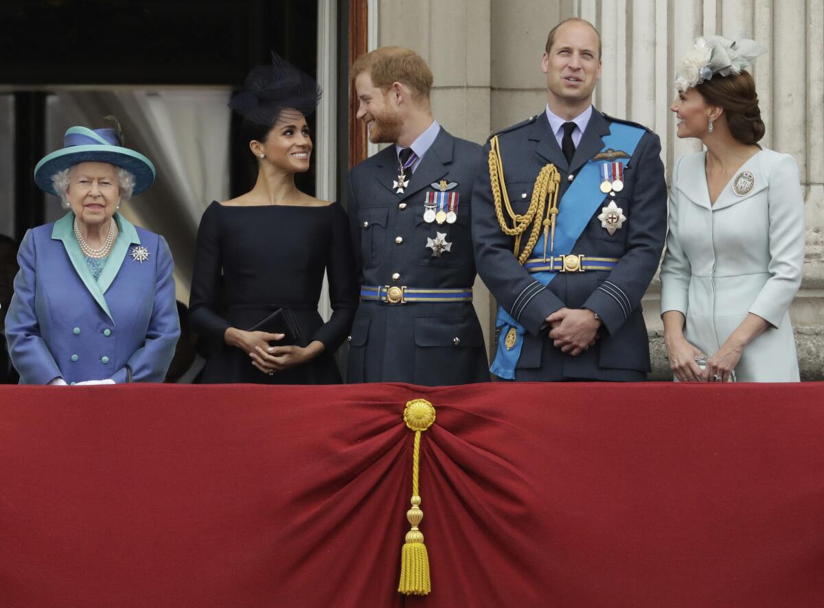 FILE - In this file photo dated Tuesday, July 10, 2018, Britain's Queen Elizabeth II, and from left, Meghan the Duchess of Sussex, Prince Harry, Prince William and Kate the Duchess of Cambridge, watch as Royal Air Force aircraft pass over Buckingham Palace in London. Prince Harry will attend the funeral for Prince Philip on Saturday April 17, the first time that Harry will come face to face with the royal family since he and his wife Meghan, the Duchess of Sussex, stepped away from royal duties last March and moved to California with their young son, Archie.(AP Photo/Matt Dunham, FILE)
