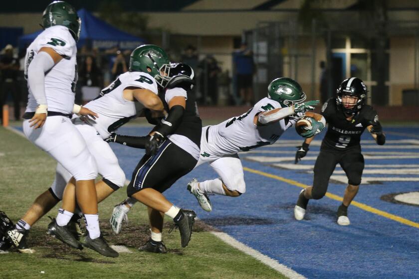 Jake Tsay of the Poway Titans dives in for the winning score in Friday nights game against the Ramona Bulldogs