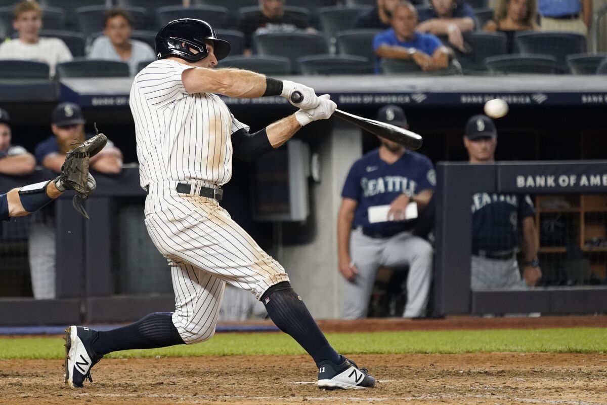 New York Yankees' Brett Gardner hits a walkoff winning RBI-single in the 11th inning of a baseball game against the Seattle Mariners, Friday, Aug. 6, 2021, in New York. (AP Photo/Mary Altaffer)