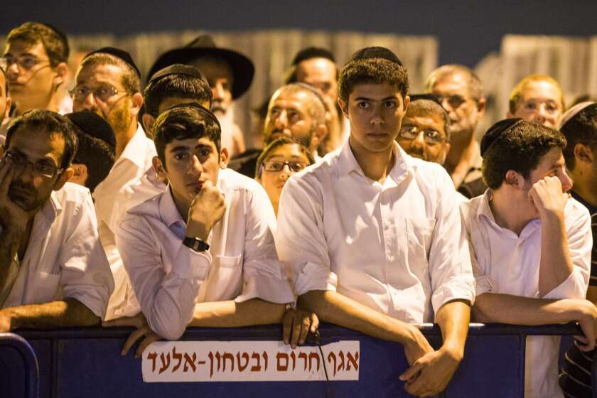 Israelis gather Monday outside the house of one of three Israeli teenagers.