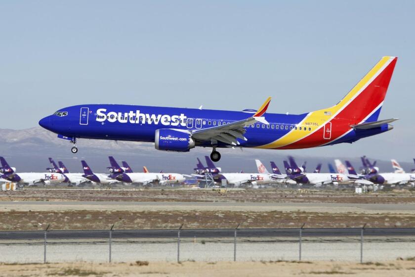 In this Saturday, March 23, 2019, photo, a Southwest Airlines Boeing 737 Max aircraft lands at the Southern California Logistics Airport in the high desert town of Victorville, Calif. Southwest, which has 34 Max aircraft, is making cancellations five days in advance, with an average of 130 daily cancellations. (AP Photo/Matt Hartman)