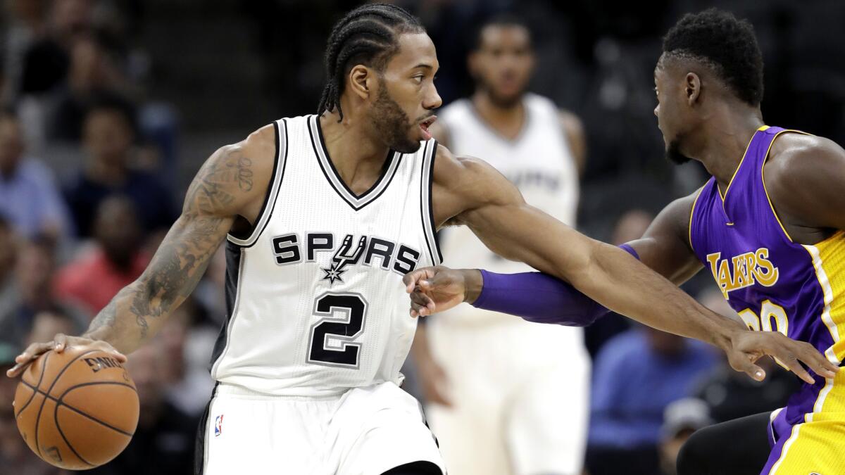 Spurs forward Kawhi Leonard drives against Lakers forward Julius Randle during the first half Thursday night in San Antonio.