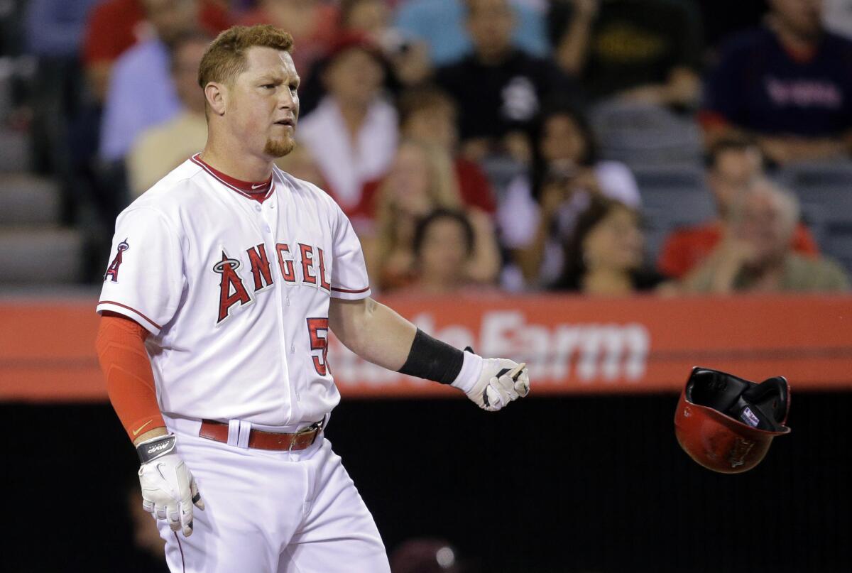 Angels right fielder Kole Calhoun tosses his helmet after striking out against the Mariners in the fifth inning Friday night in Anaheim.