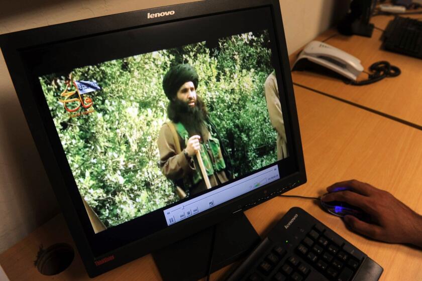 In this photograph taken on July 23, 2010, a Pakistani journalist watches a video of radical Pakistani cleric Mullah Fazlullah in Peshawar. The Pakistani Taliban announced on Thursday that they had elected him their new chief following the death of the previous leader in a drone strike.