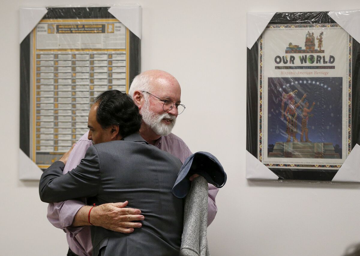 Father Greg Boyle is thanked by Eric Cuellar at Orange Coast College on April 25.