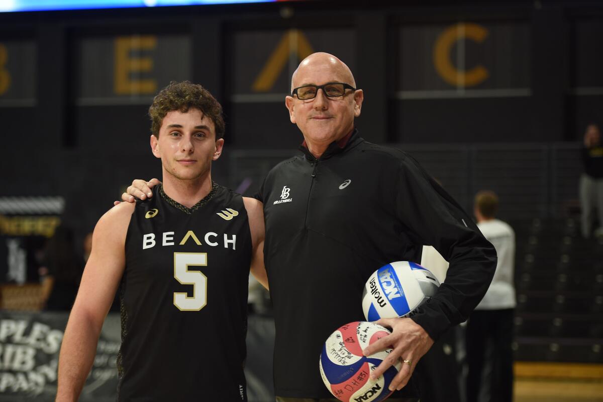 Aidan Knipe stands next his father, Long Beach State coach Alan Knipe, after the coach earned his 400th career win.
